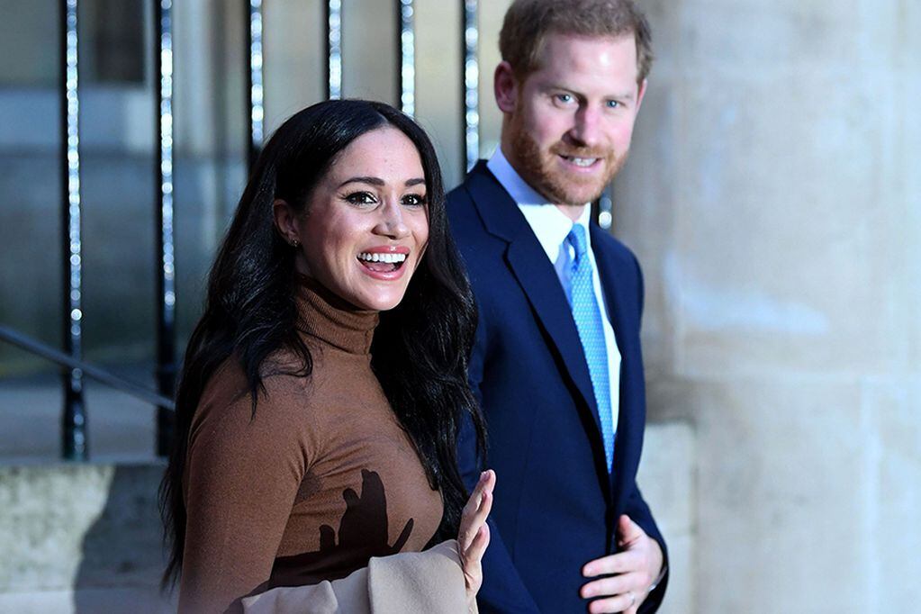 (FILES) In this file photo taken on January 07, 2020 Britain's Prince Harry, Duke of Sussex and Meghan, Duchess of Sussex react as they leave after her visit to Canada House in thanks for the warm Canadian hospitality and support they received during their recent stay in Canada, in London. - Britain's Prince Harry, Meghan are to step back as 'senior' royals, Buckingham Palace announced on January 8, 2010. (Photo by DANIEL LEAL-OLIVAS / POOL / AFP)