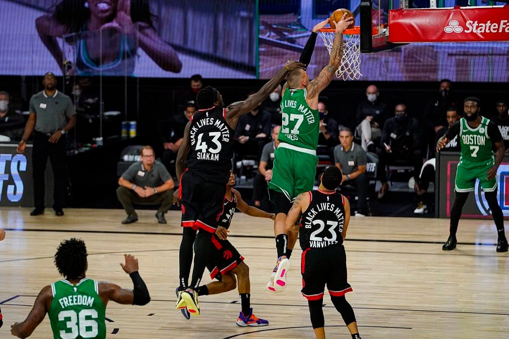 Boston Celtics center Daniel Theis (27) get a dunk in front of Toronto Raptors forward Pascal Siakam (43) during the second half of an NBA conference semifinal playoff basketball game Wednesday, Sept. 9, 2020, in Lake Buena Vista, Fla. (AP Photo/Mark J. Terrill)