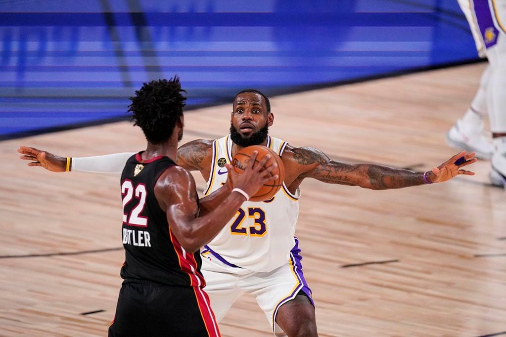 Los Angeles Lakers' LeBron James (23) attempt to block Miami Heat's Jimmy Butler (22) during the first half in Game 3 of basketball's NBA Finals, Sunday, Oct. 4, 2020, in Lake Buena Vista, Fla. (AP Photo/Mark J. Terrill)